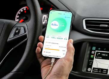 A person holding a smartphone displaying customizable charging options for an electric vehicle charger, with the phone connected to a car's dashboard.
