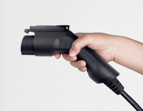 Hand holding the BESEN J1772 EV charging plug, demonstrating the comfortable and ergonomic grip.