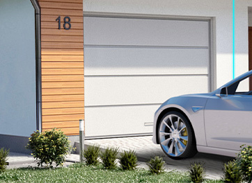 Electric car parked outside a modern home with a garage, demonstrating the convenience of using BESEN 40-amp portable EV chargers for flexible home charging without permanent installations.