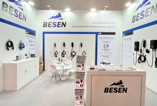 Exhibition booth showcasing BESEN EV charging products, including wall-mounted chargers, portable chargers, charging cables, and product brochures on display counters.