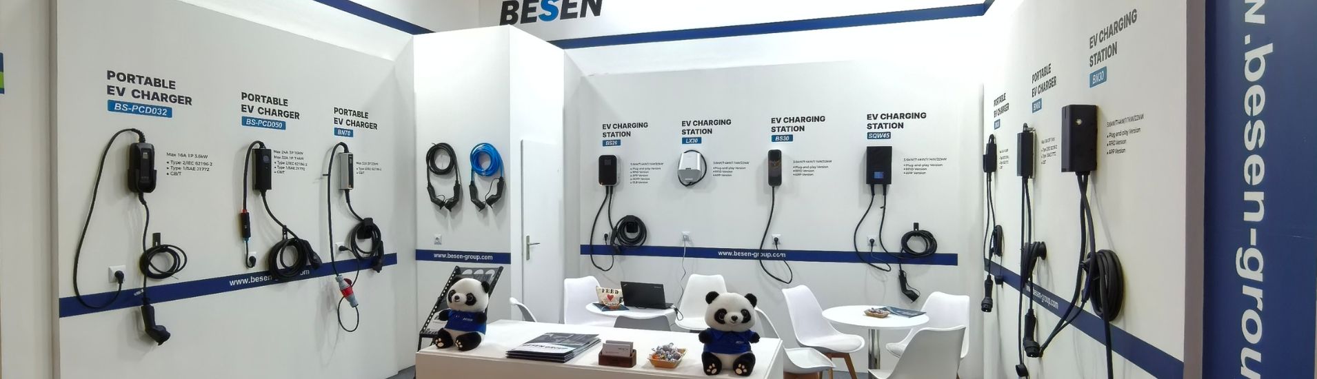EV charging product display at a BESEN trade show booth featuring portable chargers, wall-mounted charging stations, and charging cables.