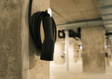 EV charging cable stored on a wall-mounted holder